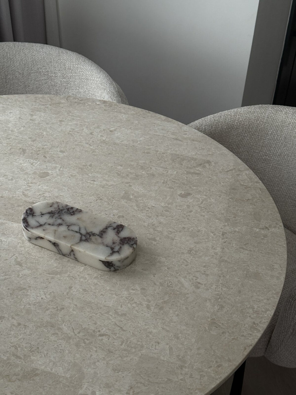 ourside Calacatta Viola marble pill box on a round stone table