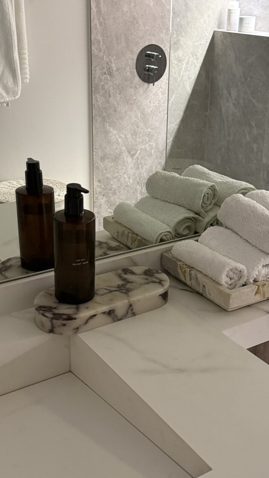 ourside marble pill box on a bathroom vanity with folded towels