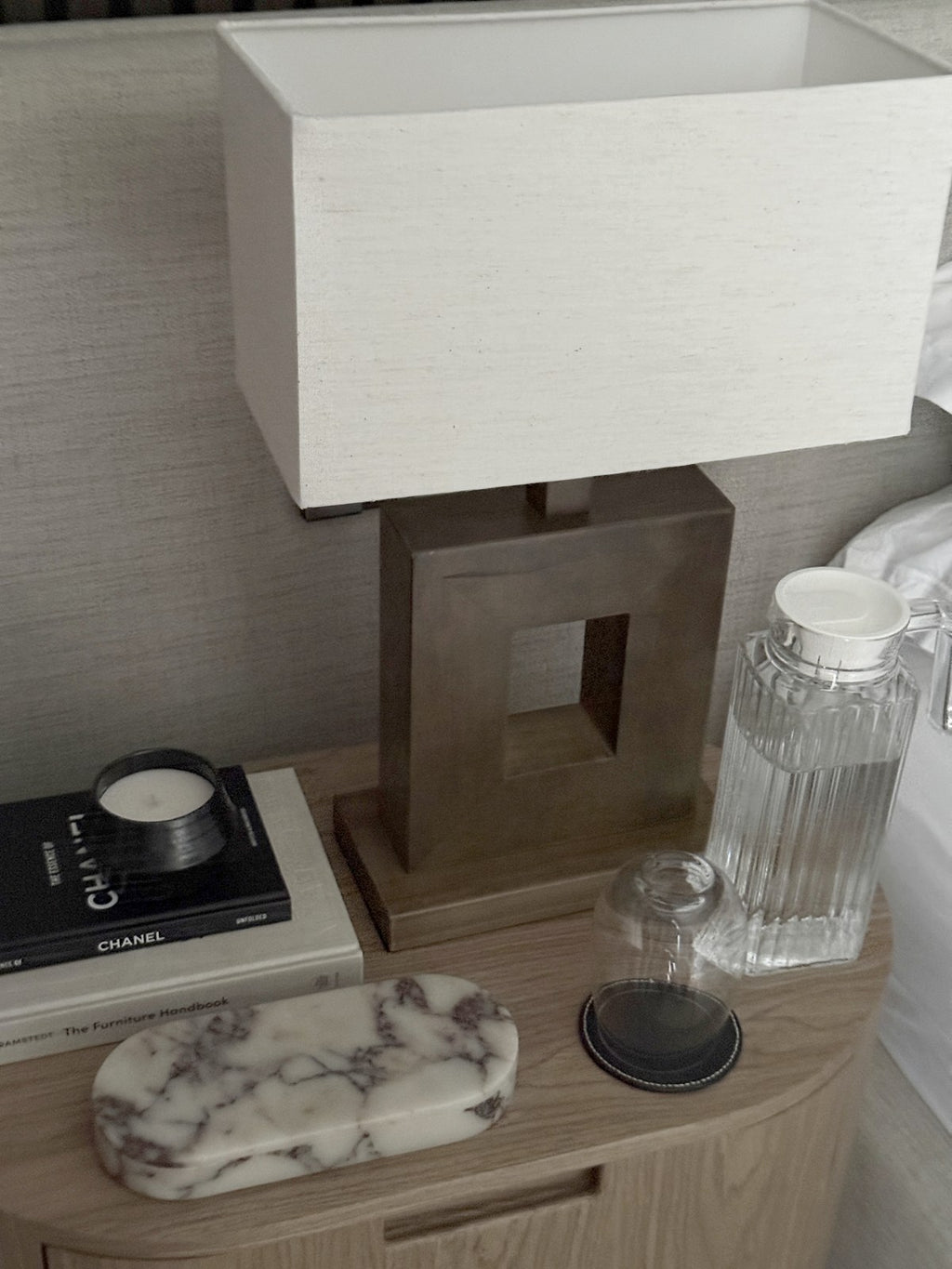 The ourside marble pill box on an oak bedside table