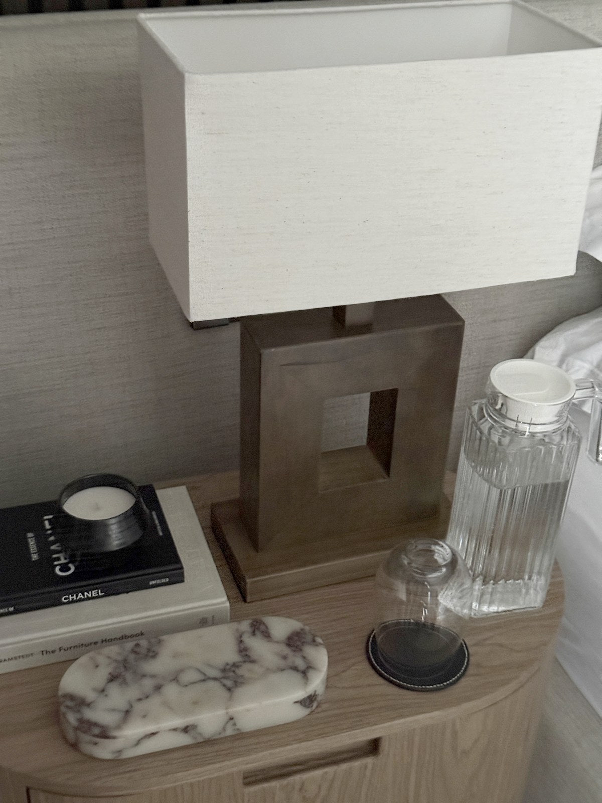The ourside marble pill box on an oak bedside table